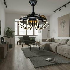 a living room filled with furniture and a chandelier hanging from the middle of it