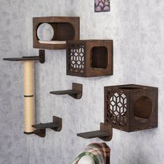 the cat tree is made from wood and has several different types of shelves on it