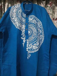 a blue shirt with white designs on it