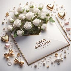 a bouquet of white flowers sitting on top of an envelope with the words happy birthday