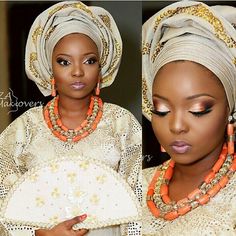 an african woman wearing a white head wrap with orange beads on her necklaces and holding a purse