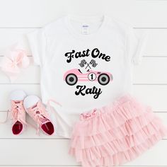 Fast One Girl Birthday Shirts, Pink Race Car Girls Birthday Shirt, 1st Birthday Shirt, Pink Race Car Matching Family Birthday Shirts,  Our shirts offer 100% customization. Add any family member and any text you desire. Simply send us a message or leave your specifications in the personalization box. We'll bring your vision to life! SHIRT DETAILS Experience comfort and style with our exceptional cotton shirt. Crafted from 100% soft cotton fibers (fiber content may vary for different colors), this shirt offers a luxurious feel against your skin. We proudly present two variants to cater to your needs: Adult and Youth Shirts are skillfully designed using the Bella + Canvas 3001 fabric, while our Toddler and Baby shirts are expertly crafted from Bella + Canvas, Gildan, and Rabbit Skins material First Birthday Name Print Top, Pink Crew Neck Shirt For First Birthday, Race Car Girls, Pink Race Car, Girls Birthday Shirt, 1st Birthday Shirt, 2nd Birthday Outfit, Race Car Birthday Party, Family Birthday Shirts