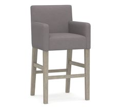 a gray upholstered bar stool with wooden legs and armrests, viewed from the front