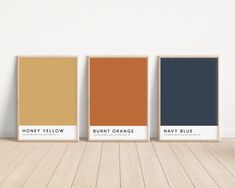 three different shades of orange, burnt orange, and navy blue are on the wall