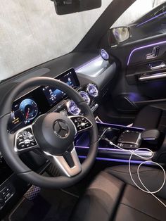 the interior of a car with electronic controls and steering wheel, including an entertainment system