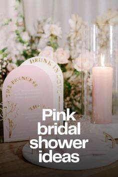 the pink bridal shower ideas are on display with candles and flowers in vases