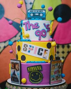 a multi - tiered cake decorated with the 90's and various movie memorabilia