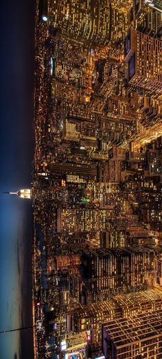 an aerial view of the city lights at night from high up in the building structure