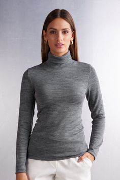 Long sleeve high collar top in 100% natural fabric with cotton against the skin and a soft and warm wool and silk blend exterior. Very comfortable breathable fabric suitable for the coldest weather but also perfect for the most delicate and sensitive skin. Very versatile basic line ideal either worn on its own or underneath a shirt or jacket. Regular fit.
The model is 5’ 9” (175 cm) tall and is wearing a size S. Solid Merino Wool Tops For Winter, Fitted Merino Wool Turtleneck For Fall, Fall Wool Top With Funnel Neck, Snug Turtleneck Tops For Winter, Wool Funnel Neck Tops For Fall, Fitted Merino Wool Turtleneck Long Sleeve, Stretch Merino Wool Turtleneck Top, Fitted Merino Wool Turtleneck With Long Sleeves, Fitted Fine Knit Merino Wool Tops