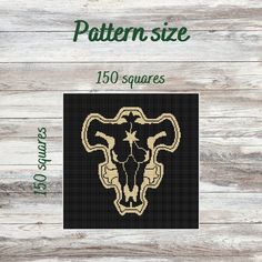 a cross stitch pattern with an animal's skull in the center on a wooden background