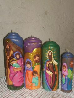 there are five candles that have been decorated with the nativity scene on them, including jesus and mary