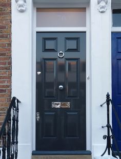 a black front door on a brick building