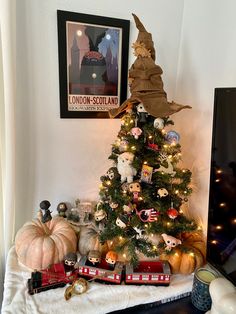 a small christmas tree with lots of toys around it and a train on the table