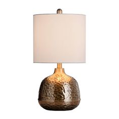 a table lamp with a white shade on the base and a gold - plated finish