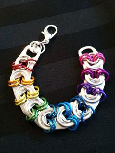 an image of a bracelet made out of different colors and metal links on a cell phone