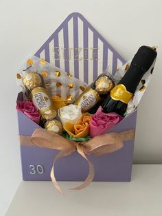 a purple box filled with champagne and chocolates