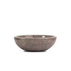 a gray bowl sitting on top of a white surface