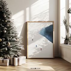 a christmas tree is next to a framed photograph