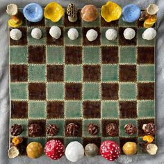 a checker board made out of different types of candies and nuts on a blanket