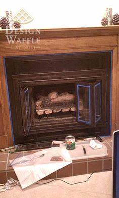 a fireplace with some bread in it and a laptop on the floor next to it