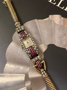 "Amazing Retro Diamond and Ruby 10K Watch with Snake Chain Bracelet The watch is set with sparkling single cut diamonds, and channel set rubies. The watch is not in working condition, as it is very old, very hard to service, it is a collectible piece. 1/2\" wide And the watch can be worn 6.5-6.75\" 30.55g No markings, the watch tests for 10K gold." Vintage Diamond Jeweled Jewelry, Vintage Diamond Watch, Vintage Yellow Gold Diamond Watch With 17 Jewels, Vintage Ruby Jewelry With Diamond Accents, Vintage Ruby Evening Jewelry, Luxury Vintage Diamond Watch With Subdials, Vintage Watches With Diamond Accents, Luxury Gift Vintage Diamond Watch, Antique Diamond Watch With Diamond Hour Markers