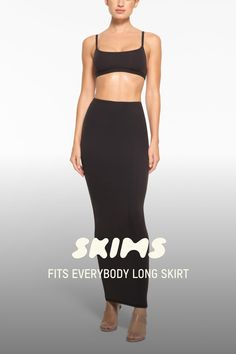 a woman in a black skirt and crop top with the words skims on it