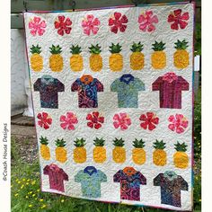 a quilt made to look like pineapples and polo shirts with flowers on them