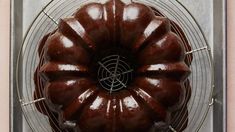 a chocolate bundt cake sitting on top of a cooling rack