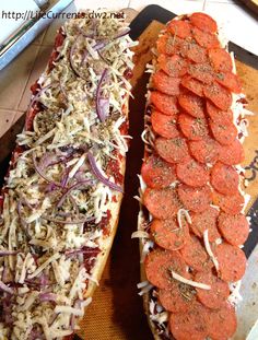 two hot dogs with toppings are on a cutting board next to each other, ready to be cooked