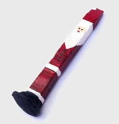 a red and white wooden santa clause ornament