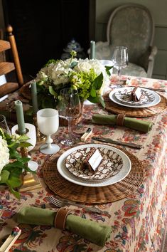 a table set with place settings and flowers