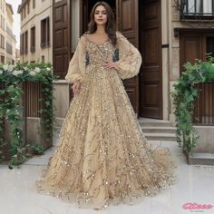 a woman standing in front of a building wearing a gold gown with sequins