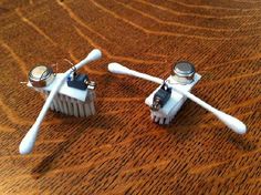 two tooth brushes sitting on top of a wooden table