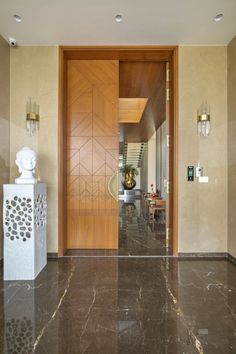 an entry way with marble floors and wooden doors