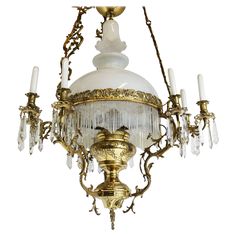 an antique chandelier with glass and brass accents