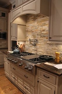 a kitchen with an oven, stove and counter top in the middle of it's wood flooring