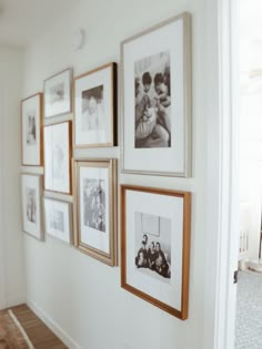 a wall with many pictures hanging on it