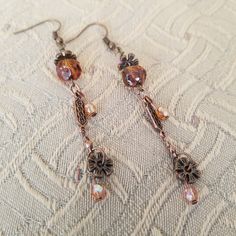 Bronze French hook wire dangle bead earrings with bronze faceted Czech glass and crystal beads with copper and bronze accents Drop length is 3 inches. Lightweight. Make a statement with these long, swinging, fun pair of warm colored Czech faceted glass dangle earrings that can be worn all year long with either a dressy or casual outfit.  A nice gift for that someone special in your life! Bronze Copper Beaded Earrings As Gift, Brown Copper Beaded Earrings With Dangling Beads, Bronze Copper Dangle Beaded Earrings, Bronze Czech Glass Dangle Jewelry, Brown Copper Beaded Dangling Earrings, Handmade Bronze Czech Glass Earrings, Bronze Copper Beaded Dangle Earrings, Bronze Copper Earrings With Dangling Beads, Brown Czech Glass Dangle Earrings