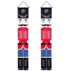 two wooden nutcrackers are hanging on the wall, one is wearing a red and blue uniform