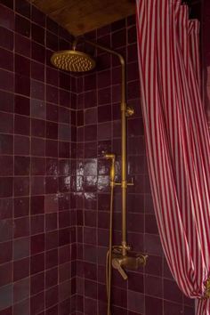 a shower with red and white striped curtains