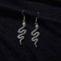 High quality, dainty sterling snake earrings. These sharp earrings are handcrafted with sterling silver ear hooks, and with proper care, will not tarnish so that you may wear these anytime. Earrings are packaged with an anti-tarnishing rag so that you may brighten them up and keep them sparkling. Rubber earrings backs are attached so that you never have to worry about losing them. These incredible earrings are lightweight and the perfect gift for anyone- even yourself! If you have any questions Silver Snake Shaped Metal Earrings, Silver Snake-shaped Metal Earrings, Silver Snake Shape Metal Earrings, Silver Snake-shaped Earrings, Snake-shaped Earrings With Ear Wire As Gift, Snake-shaped Single Earring As Gift, Snake-shaped Earrings With Ear Wire For Gift, Snake Shaped Single Earring As Gift, Silver Snake-shaped Single Earring