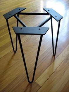 two metal tables sitting on top of a wooden floor