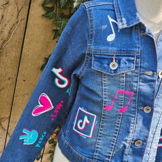 This stylish TikTok Denim Jacket is perfect for any fan of the trendy platform. It's made with a lightweight denim fabric and features a unique multicolored design, with blue, black, and pink glitter elements. Celebrate birthdays or special occasions with this fun and fashionable TikTok-themed jacket. These jackets run TRUE TO SIZE. Please note that jackets are personalized and made to order. They will not always be exact replicas. Denim color may vary. Trendy Denim Jacket With Patches, Multicolor Denim Jacket With Patches For Spring, Multicolor Patched Denim Jacket For Spring, Fun Cotton Denim Jacket For Fall, Trendy Multicolor Denim Jacket, Fun Cotton Outerwear For Spring, Fun Spring Denim Jacket, Trendy Multicolor Long Sleeve Denim Jacket, Trendy Fitted Pink Denim Jacket