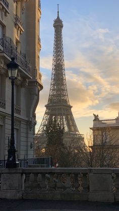 the eiffel tower is seen from across the street in paris, france at sunset