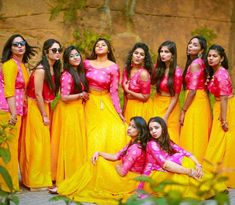 a group of women in yellow and pink dresses