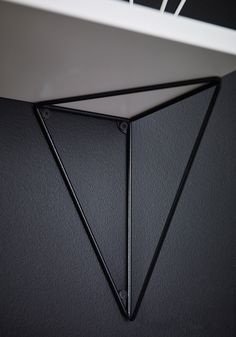 the corner of a wall with a black triangle on it