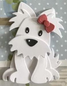 a white dog with a red bow on it's head sitting in front of a polka dot background