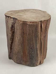 a wooden stool made out of tree trunks