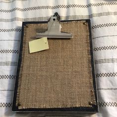 a clipboard with a piece of paper attached to it on top of a bed