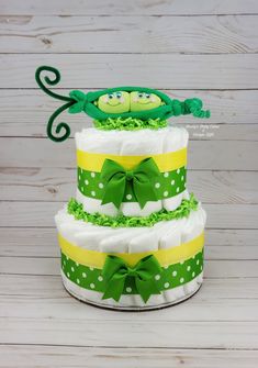 a three tiered cake with green and yellow decorations